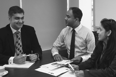 Three charity auditors sitting at a table